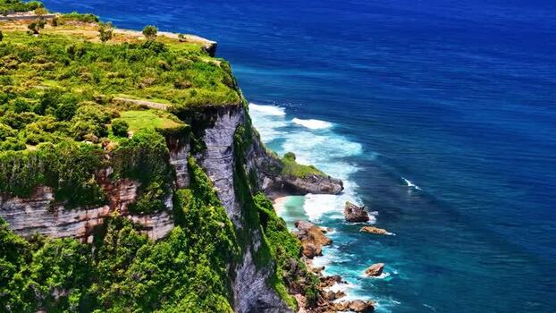 Aerial view of Uluwatu cliffs above the ocean in Indonesia.