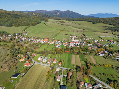 Aerial view of the quaint village nestled amongst a patchwork of green and golden fields framed by the distant rolling hills Klastor pod Znievom Zilina Region Slovakia. Aerial view of the quaint village nestled amongst a patchwork of green and golden fields framed by the distant rolling hills Klastor pod Znievom Zilina Region Slovakia.