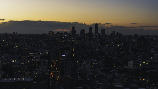 View of the city lights twinkling against the fading twilight sky silhouetting skyscrapers in the distance creating a mesmerizing urban panorama Bunkyo City Tokyo Japan. View of the city lights twinkling against the fading twilight sky silhouetting skyscrapers in the distance creating a mesmerizing urban panorama Bunkyo City Tokyo Japan.