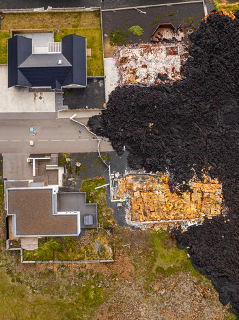 Aerial view of residential houses destroyed by a volcanic lava flow in Iceland. Aerial view of residential houses destroyed by a volcanic lava flow in Iceland.