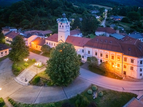 Aerial view of the striking white tower of the Church of St. Thomas rising above the town square nestled amidst the lush greenery Gelnica Kosice Region Slovakia. Aerial view of the striking white tower of the Church of St. Thomas rising above the town square nestled amidst the lush greenery Gelnica Kosice Region Slovakia.