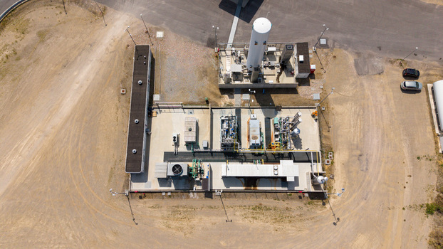 Aerial view of a modern biomethane production facility with storage tanks processing units and a fueling station in Tavazzano con Villavesco Lombardy Italy.