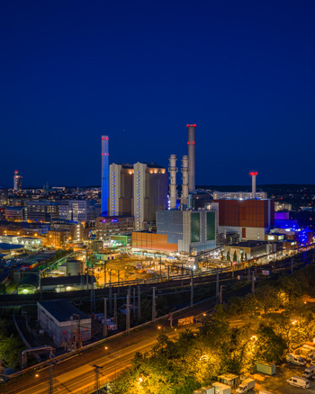 Aerial view of MAINOVA AG Heizkraftwerk West with illuminated chimneys and industrial structures at night in Frankfurt am Main Hessen Germany. Aerial view of MAINOVA AG Heizkraftwerk West with illuminated chimneys and industrial structures at night in Frankfurt am Main Hessen Germany.