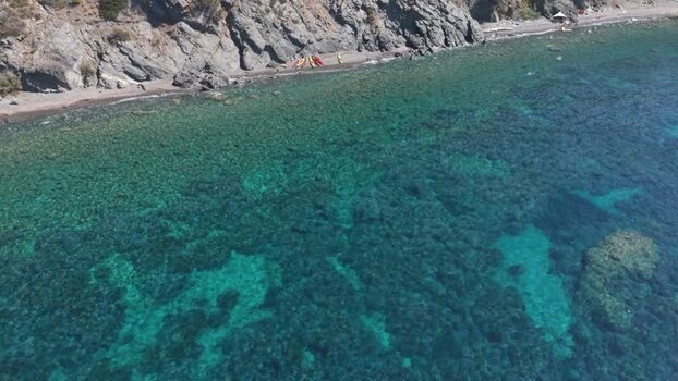 Aerial view of Pomonte coastline and turquoise water Italy.