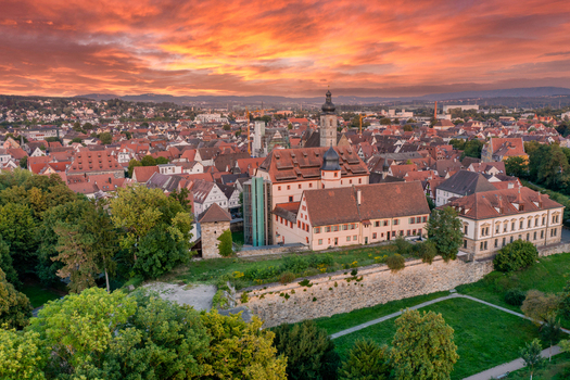 Aerial view of Forchheim Castle with its historic stone walls and red tiled roofs under a vibrant sunset sky in Forchheim Bayern Germany. Aerial view of Forchheim Castle with its historic stone walls and red tiled roofs under a vibrant sunset sky in Forchheim Bayern Germany.