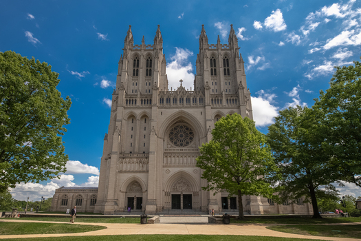 Washington District of Columbia United States 06 May 2025 View of Washington National Cathedral with intricate Gothic architecture stone facade and rose window under a blue sky.