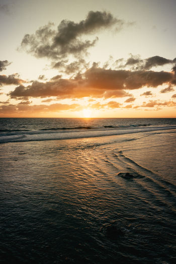 Aerial view of the sunset over the ocean at Rarotonga in the Cook Islands. Aerial view of the sunset over the ocean at Rarotonga in the Cook Islands.