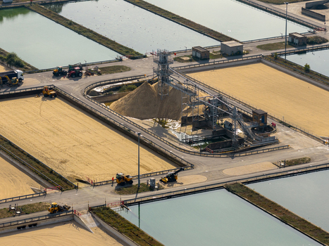 Aerial view of Ashford Common Water Treatment Works with filtration basins sand stockpiles conveyor systems and construction vehicles in Shepperton England United Kingdom. Aerial view of Ashford Common Water Treatment Works with filtration basins sand stockpiles conveyor systems and construction vehicles in Shepperton England United Kingdom.
