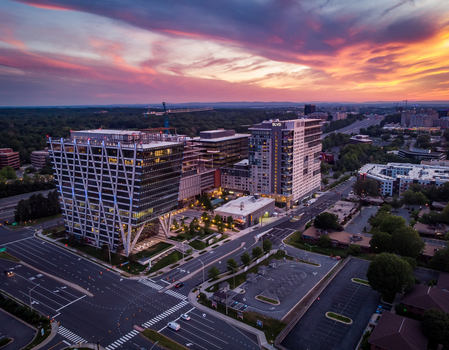 Reston Virginia United States 27 May 2020 Aerial view of modern office buildings and mixed use developments at sunset with a vibrant sky. Reston Virginia United States 27 May 2020 Aerial view of modern office buildings and mixed use developments at sunset with a vibrant sky.