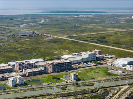 Aerial view of Mirsarai Economic Zone featuring industrial buildings under construction expansive green wetlands and infrastructure in Minsarai Chittagong Division Bangladesh. Aerial view of Mirsarai Economic Zone featuring industrial buildings under construction expansive green wetlands and infrastructure in Minsarai Chittagong Division Bangladesh.