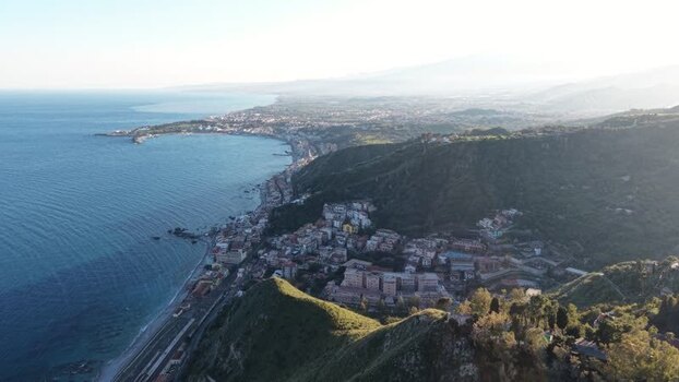 Aerial view of the coastal landscape and hills of Taormina Italy.