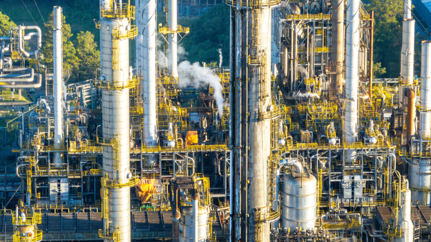Aerial view of a large petrochemical complex featuring tall industrial towers intricate piping systems and steel structures in an urban setting in Santo Andre State of Sao Paulo Brazil.