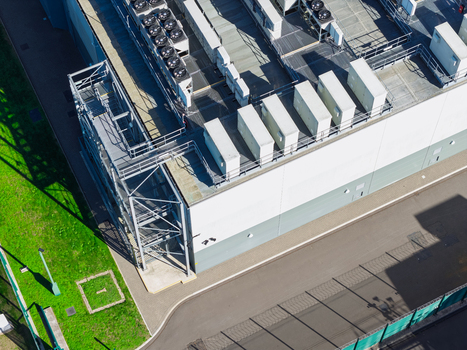 Aerial view of a data center with rooftop cooling units and metal infrastructure in the United Kingdom.