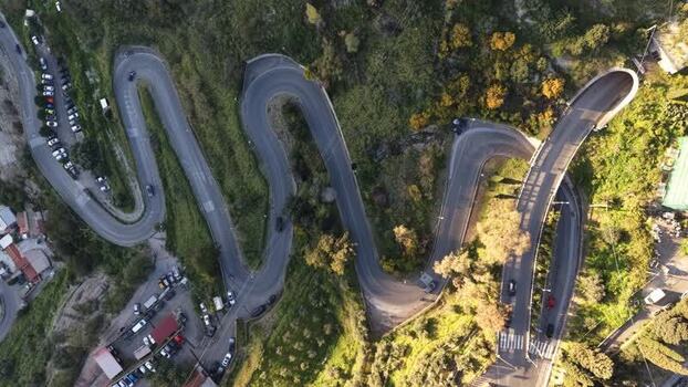 Aerial view of winding mountain roads and hairpin turns Italy.