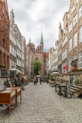 Gdansk Poland 07 September 2026 View of Mariacka Street with its historic brick townhouses stone terraces and the towering St. Mary s Church in the background under a cloudy sky. Gdansk Poland 07 September 2026 View of Mariacka Street with its historic brick townhouses stone terraces and the towering St. Mary s Church in the background under a cloudy sky.
