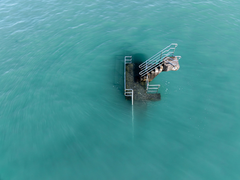 Aerial view of stairs leading into the tranquil turquoise waters of the English Channel a serene invitation to the sea Saint Malo Brittany France. Aerial view of stairs leading into the tranquil turquoise waters of the English Channel a serene invitation to the sea Saint Malo Brittany France.