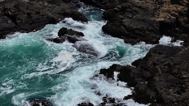 Aerial view of crashing waves on the rocky coast of United States.
