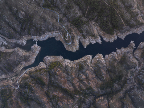 Aerial view of a winding river flowing through rocky hills and sparse vegetation in the countryside Kirklareli Merkez Kirklareli Turkiye. Aerial view of a winding river flowing through rocky hills and sparse vegetation in the countryside Kirklareli Merkez Kirklareli Turkiye.