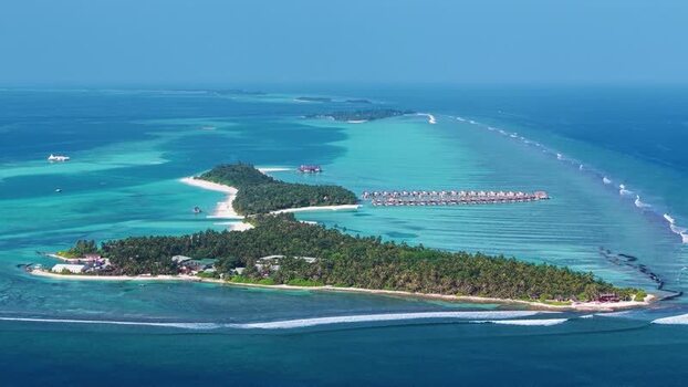 Aerial view of tropical island and overwater bungalows Maldives. Aerial view of tropical island and overwater bungalows Maldives.