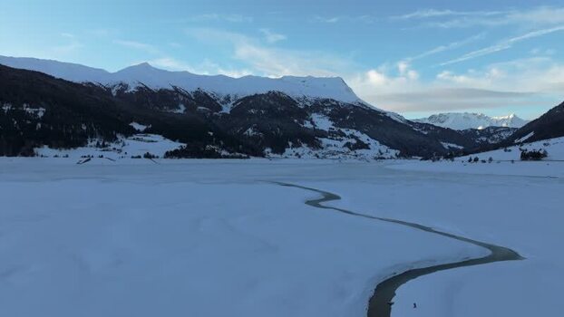 Aerial view of frozen Reschensee lake in winter Italy. Aerial view of frozen Reschensee lake in winter Italy.
