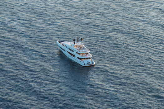 Aerial view of a luxury yacht cruising on the deep blue Mediterranean Sea in Antibes Provence Alpes Cote d Azur France. Aerial view of a luxury yacht cruising on the deep blue Mediterranean Sea in Antibes Provence Alpes Cote d Azur France.