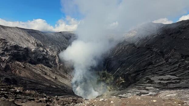 View of Mount Bromo crater emitting smoke Indonesia.