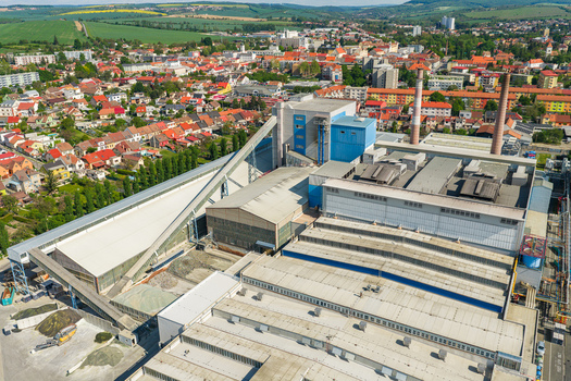 Aerial view of an industrial facility with large warehouses a conveyor belt system and tall chimneys Kyjov South Moravian Region Czechia.