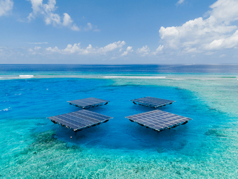 Aerial view of SolarSea floating solar power plant by Swimsol on turquoise lagoon waters with coral reefs and a clear blue sky Dharavandhoo Baa Atoll Maldives. Aerial view of SolarSea floating solar power plant by Swimsol on turquoise lagoon waters with coral reefs and a clear blue sky Dharavandhoo Baa Atoll Maldives.