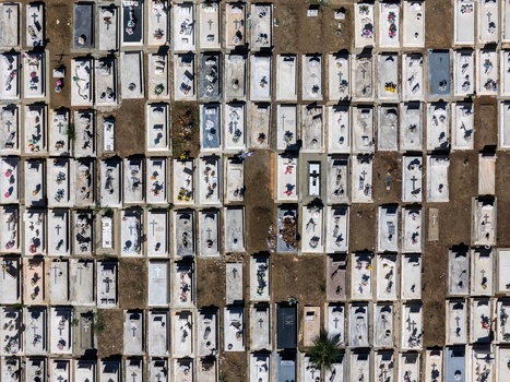 Aerial view of the cemetery with rows of rectangular graves and tombstones in Evora Evora District Portugal. Aerial view of the cemetery with rows of rectangular graves and tombstones in Evora Evora District Portugal.