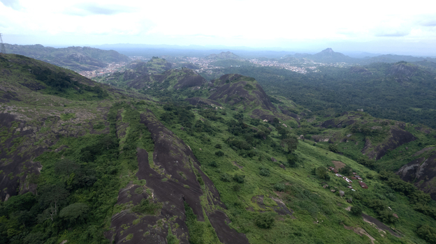 Aerial view of Idanre Hill with its dramatic rocky outcrops and lush green vegetation under a cloudy sky in Idanre Ondo State Nigeria. Aerial view of Idanre Hill with its dramatic rocky outcrops and lush green vegetation under a cloudy sky in Idanre Ondo State Nigeria.