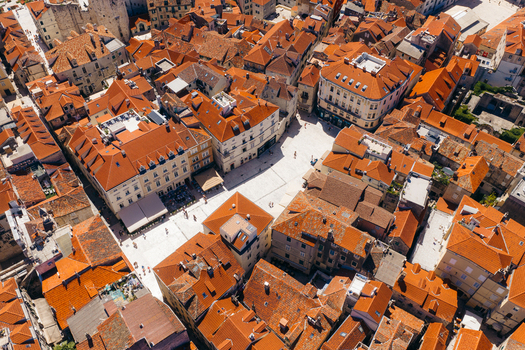 Aerial view of the historic People s Square surrounded by traditional red tiled roofs and ancient stone buildings in the old town of Split Split Dalmatia County Croatia. Aerial view of the historic People s Square surrounded by traditional red tiled roofs and ancient stone buildings in the old town of Split Split Dalmatia County Croatia.