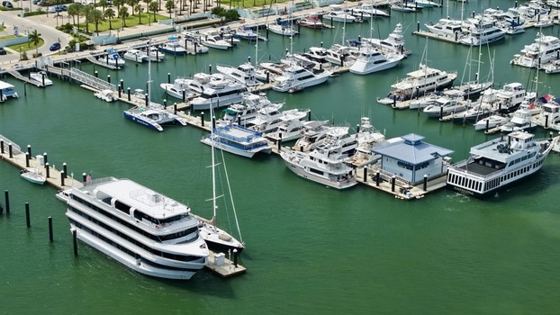 Aerial view of Peanut Island marina with yachts and a large white tour boat docked at the pier in Palm Beach County Florida United States.