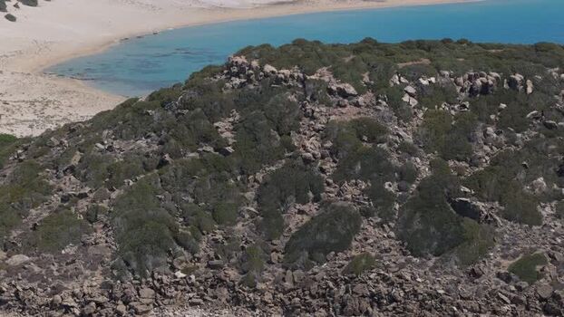 Aerial view of rocky hill and beach in Northern Cyprus.