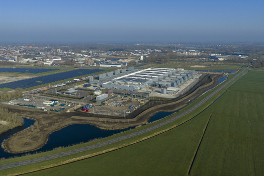 Aerial view of the Google data center with solar panels and industrial buildings surrounded by green fields and water in Winschoten Groningen Netherlands.