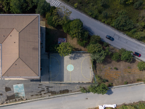 Aerial view of a sports court next to a building with a brown roof surrounded by trees and roads in Istanbul Istanbul Turkiye. Aerial view of a sports court next to a building with a brown roof surrounded by trees and roads in Istanbul Istanbul Turkiye.