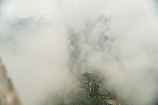 View of the valley below through thick white clouds and mist from the Ambuluwawa Tower in Gampola Central Province Sri Lanka. View of the valley below through thick white clouds and mist from the Ambuluwawa Tower in Gampola Central Province Sri Lanka.