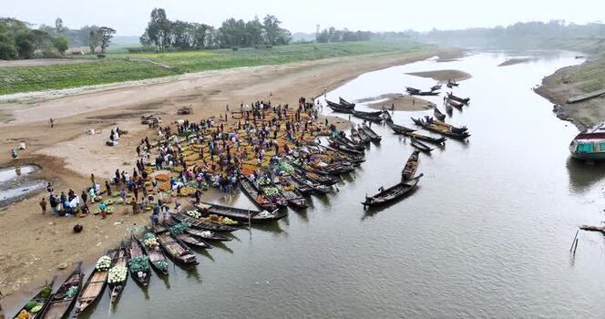 Aerial view of a busy river market with boats Bangladesh.