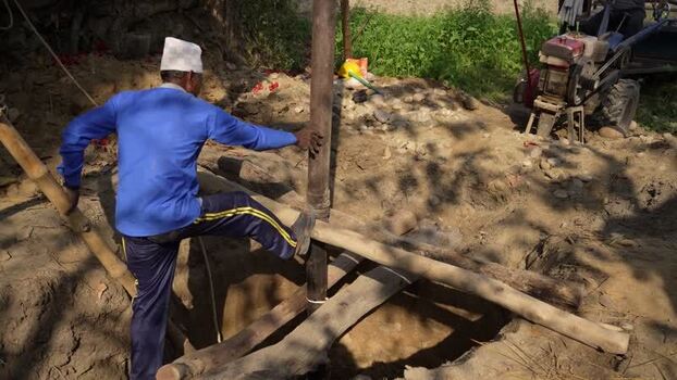 View of a man working at a construction site in Nepal. View of a man working at a construction site in Nepal.