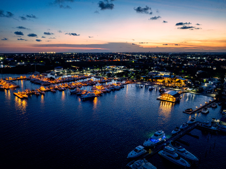Aerial view of Club Nautico de Santo Domingo Inc. marina at dusk with illuminated yachts and boats reflecting on calm water in Andres Santo Domingo Dominican Republic. Aerial view of Club Nautico de Santo Domingo Inc. marina at dusk with illuminated yachts and boats reflecting on calm water in Andres Santo Domingo Dominican Republic.