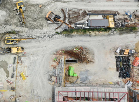 Aerial view of a busy construction site featuring excavators rebar piles and building materials in Sariyer Istanbul Turkiye. Aerial view of a busy construction site featuring excavators rebar piles and building materials in Sariyer Istanbul Turkiye.