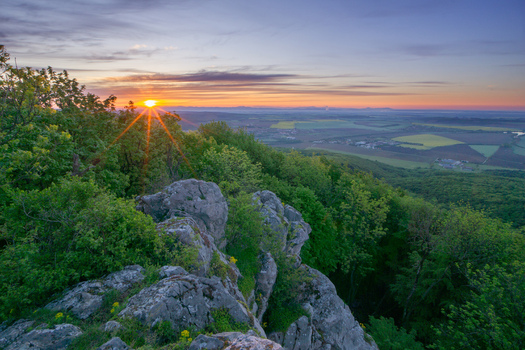 View of Havrania skala in Male Karpaty mountains with rocky outcrops and lush green forests at sunset Smolenice Trnava Region Slovakia. View of Havrania skala in Male Karpaty mountains with rocky outcrops and lush green forests at sunset Smolenice Trnava Region Slovakia.