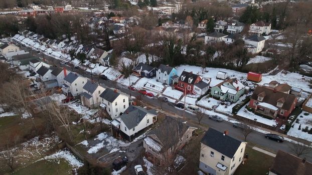 Aerial view of a residential neighborhood in Southwest Lynchburg during sunset featuring houses with snow covered roofs bare trees and quiet streets in Lynchburg Virginia United States. Aerial view of a residential neighborhood in Southwest Lynchburg during sunset featuring houses with snow covered roofs bare trees and quiet streets in Lynchburg Virginia United States.