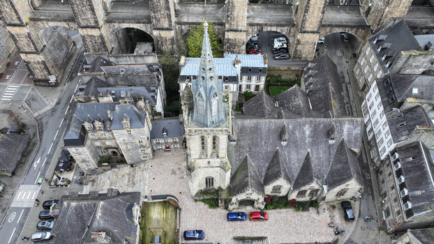 Aerial view of the Eglise Saint Melaine de Morlaix with its tall gothic spire and historic stone buildings near the massive viaduct in Morlaix Bretagne France. Aerial view of the Eglise Saint Melaine de Morlaix with its tall gothic spire and historic stone buildings near the massive viaduct in Morlaix Bretagne France.