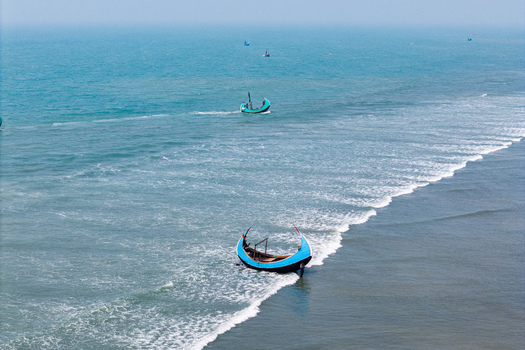 Cox s Bazar Bangladesh 10 March 2026 Aerial view of traditional moon shaped fishing boats floating on the turquoise waters of the Bay of Bengal near the sandy shore. Cox s Bazar Bangladesh 10 March 2026 Aerial view of traditional moon shaped fishing boats floating on the turquoise waters of the Bay of Bengal near the sandy shore.