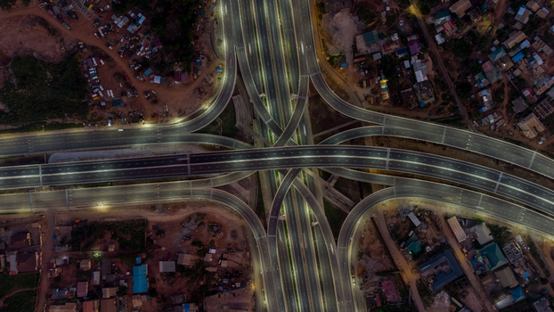 Aerial view of Pokuase Interchange at night with illuminated multi level highway ramps smooth asphalt roads and surrounding urban development in Ga North Municipal Greater Accra Region Ghana. Aerial view of Pokuase Interchange at night with illuminated multi level highway ramps smooth asphalt roads and surrounding urban development in Ga North Municipal Greater Accra Region Ghana.