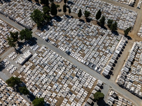 Aerial view of the cemetery with rows of white grave markers and narrow paths in Evora Evora District Portugal. Aerial view of the cemetery with rows of white grave markers and narrow paths in Evora Evora District Portugal.