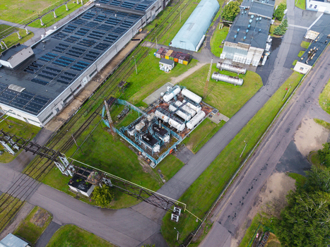 Olaine parish Latvia 04 July 2026 Aerial view of an industrial facility featuring storage tanks railway tracks and warehouse buildings surrounded by green fields. Olaine parish Latvia 04 July 2026 Aerial view of an industrial facility featuring storage tanks railway tracks and warehouse buildings surrounded by green fields.