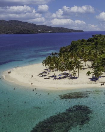 Aerial view of Cayo Levantado Beach with turquoise waters coral reefs palm trees and beach chairs on the white sand in Samana SAMANA Dominican Republic. Aerial view of Cayo Levantado Beach with turquoise waters coral reefs palm trees and beach chairs on the white sand in Samana SAMANA Dominican Republic.