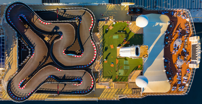 Aerial view of the Nassau Cruise Port featuring a go kart track mini golf course and lounge area with people relaxing on the deck of a cruise ship in Nassau The Bahamas. Aerial view of the Nassau Cruise Port featuring a go kart track mini golf course and lounge area with people relaxing on the deck of a cruise ship in Nassau The Bahamas.