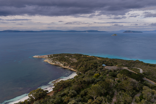 Aerial view of Frenchman Bay with its turquoise waters sandy beach and dense coastal vegetation along the rocky headland Albany Western Australia Australia. Aerial view of Frenchman Bay with its turquoise waters sandy beach and dense coastal vegetation along the rocky headland Albany Western Australia Australia.